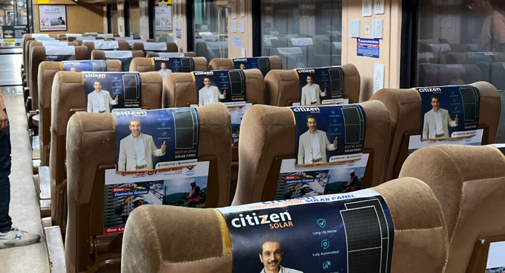 Tejas Express train advertising with headrest branding and overhead LED screen